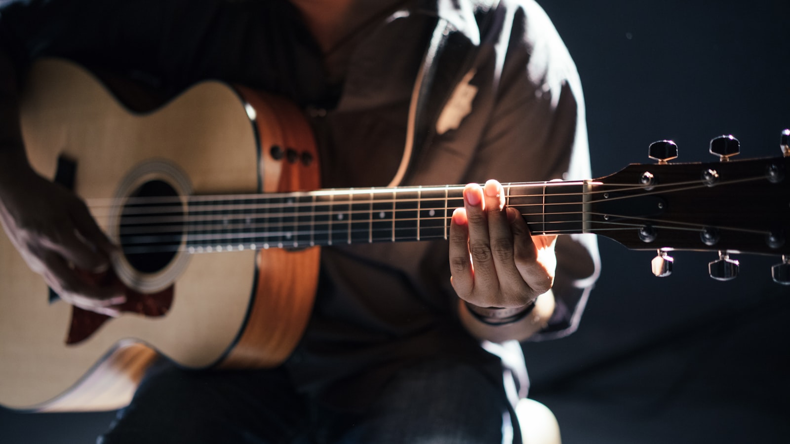 Close-up of the tuning pegs on a guitar headstock.