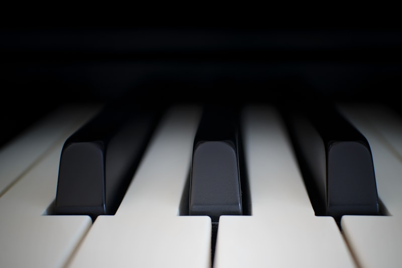 A person's hands resting gently on the keys of a piano.