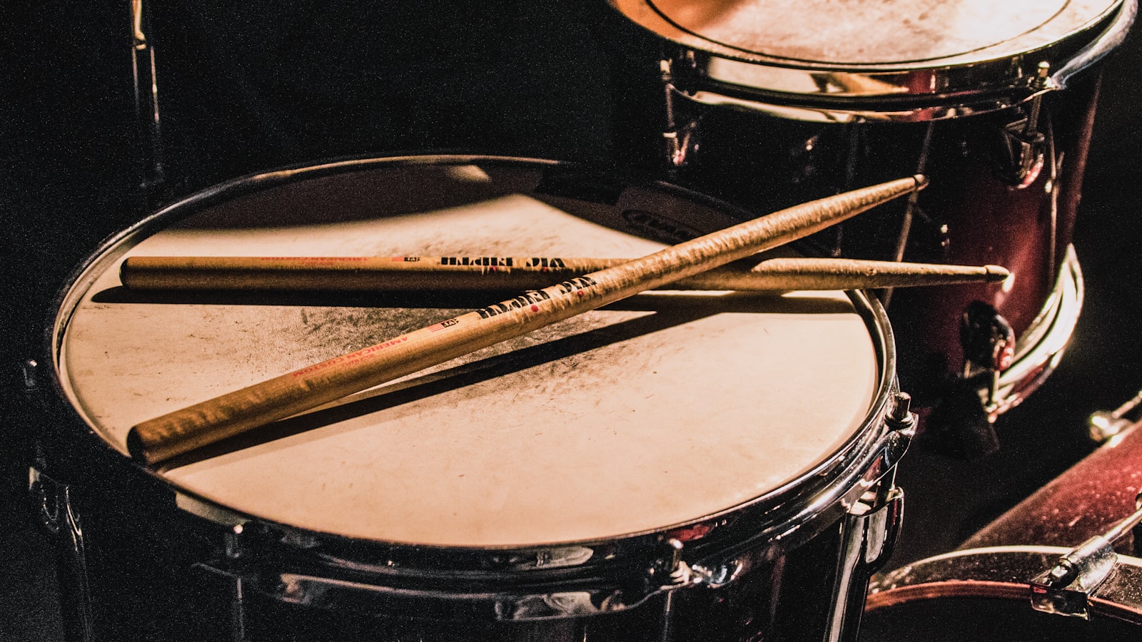 A person sitting with an instrument at home, taking a thoughtful pause during practice.