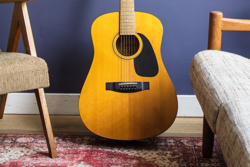 Fingertips pressing down on guitar strings near the fretboard.